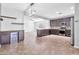 Modern kitchen with dark cabinets, stainless steel appliances, and granite countertops at 34384 N Barka Trl, San Tan Valley, AZ 85143