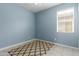 Light blue bedroom with patterned rug and window blinds at 41356 W Jenna Ln, Maricopa, AZ 85138