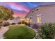 Artificial turf backyard with a view of the home's exterior at 41844 W Rosa Dr, Maricopa, AZ 85138