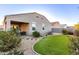 Home's back exterior and landscaped backyard with a grassy area at 41844 W Rosa Dr, Maricopa, AZ 85138
