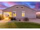 Home's back exterior and landscaped backyard with a grassy area at 41844 W Rosa Dr, Maricopa, AZ 85138