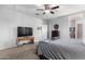Bedroom with flat-screen TV and built-in shelving at 41844 W Rosa Dr, Maricopa, AZ 85138