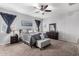 Spacious bedroom with ceiling fan and ensuite bathroom at 41844 W Rosa Dr, Maricopa, AZ 85138