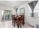 Dining area with a wooden table and chairs, leading to a patio at 41844 W Rosa Dr, Maricopa, AZ 85138