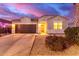 Charming house with a landscaped front yard, driveway, and two-car garage at 41844 W Rosa Dr, Maricopa, AZ 85138