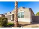 Front view of the house with a palm tree and well-maintained landscaping at 41844 W Rosa Dr, Maricopa, AZ 85138