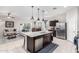 Kitchen with granite island, stainless steel appliances, and open floor plan at 41844 W Rosa Dr, Maricopa, AZ 85138