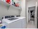 Laundry room with washer, dryer, and shelving at 41844 W Rosa Dr, Maricopa, AZ 85138