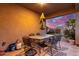 Covered patio with seating area, perfect for outdoor dining and relaxation at 41844 W Rosa Dr, Maricopa, AZ 85138