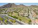 Aerial view of community with homes, green spaces, and mountains in background at 5512 W Cavedale Dr, Phoenix, AZ 85083