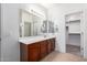 Double vanity bathroom with a large mirror and walk-in closet at 5512 W Cavedale Dr, Phoenix, AZ 85083