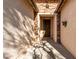 Covered entryway with stone accents and a dark brown door at 5512 W Cavedale Dr, Phoenix, AZ 85083