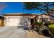 Single-story home with a two-car garage and well-manicured landscaping at 5512 W Cavedale Dr, Phoenix, AZ 85083