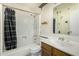 White bathroom with shower/tub combo, vanity, and toilet at 5530 N 47Th Ave, Glendale, AZ 85301