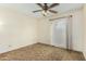 Bedroom with brown carpet, ceiling fan, and window at 5530 N 47Th Ave, Glendale, AZ 85301