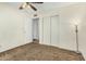 Bedroom with brown carpet, ceiling fan, and closet at 5530 N 47Th Ave, Glendale, AZ 85301