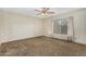 Bedroom with brown carpet, ceiling fan, and window at 5530 N 47Th Ave, Glendale, AZ 85301