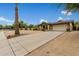 House exterior showcasing a spacious front yard and a palm tree at 5530 N 47Th Ave, Glendale, AZ 85301
