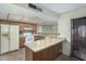 Kitchen with granite countertops, wood cabinets, and breakfast bar at 5530 N 47Th Ave, Glendale, AZ 85301