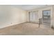 Bright and airy living room with neutral carpeting and access to the exterior at 5530 N 47Th Ave, Glendale, AZ 85301