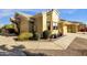 Tan house exterior with landscaped walkway and potted plants at 5830 E Mckellips Rd # 66, Mesa, AZ 85215