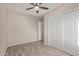 Well-lit bedroom with ceiling fan and double door closet at 6443 E Alder Ave, Mesa, AZ 85206