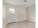 Well-lit bedroom with white door and grey tile flooring at 6443 E Alder Ave, Mesa, AZ 85206