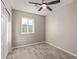 Bright bedroom with wood-look floors, ceiling fan, and double doors at 6443 E Alder Ave, Mesa, AZ 85206