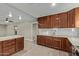 Modern kitchen featuring dark wood cabinets and white countertops at 6443 E Alder Ave, Mesa, AZ 85206
