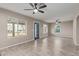 Open living room with tile floors and ceiling fans at 6443 E Alder Ave, Mesa, AZ 85206