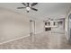 Open concept living room with kitchen view and ceiling fans at 6443 E Alder Ave, Mesa, AZ 85206