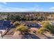 Aerial view of single-story home with pool, expansive yard, and mountain views at 6613 W Sweetwater Ave, Glendale, AZ 85304