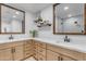 Bathroom with dual vanity, quartz countertops and modern fixtures at 6613 W Sweetwater Ave, Glendale, AZ 85304
