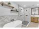 Modern bathroom with herringbone tile shower, freestanding tub, and dual vanity at 6613 W Sweetwater Ave, Glendale, AZ 85304