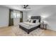 Bright bedroom with gray bed frame, ceiling fan, and wood-look flooring at 6613 W Sweetwater Ave, Glendale, AZ 85304