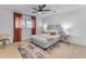 Bedroom with ceiling fan, terracotta curtains, and light flooring at 6613 W Sweetwater Ave, Glendale, AZ 85304