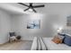 Bedroom with striped bedspread, ceiling fan, and artwork at 6613 W Sweetwater Ave, Glendale, AZ 85304