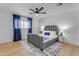 Spacious bedroom with gray bed frame, ceiling fan and rug at 6613 W Sweetwater Ave, Glendale, AZ 85304