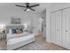 Bright bedroom with ceiling fan, ample closet space, and light flooring at 6613 W Sweetwater Ave, Glendale, AZ 85304