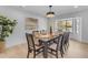 Modern dining room with a large table, six chairs, and a view of the backyard at 6613 W Sweetwater Ave, Glendale, AZ 85304