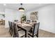 Modern dining room with a large dark wood table and seating for eight at 6613 W Sweetwater Ave, Glendale, AZ 85304