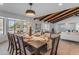 Spacious dining area with large windows, seating for six, and an open floor plan at 6613 W Sweetwater Ave, Glendale, AZ 85304