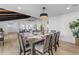 Bright dining room features a wood table with seating for six and a view into the living room at 6613 W Sweetwater Ave, Glendale, AZ 85304