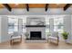 Living area featuring a contemporary fireplace and large windows at 6613 W Sweetwater Ave, Glendale, AZ 85304