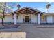 Inviting front entrance with a dark gray door, covered porch, and a welcoming mat at 6613 W Sweetwater Ave, Glendale, AZ 85304