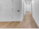 Bright hallway with light wood flooring and modern doors at 6613 W Sweetwater Ave, Glendale, AZ 85304