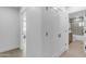 Hallway with white doors and wood-look flooring, offering access to other rooms at 6613 W Sweetwater Ave, Glendale, AZ 85304