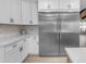 Modern kitchen with stainless steel refrigerator and white cabinetry at 6613 W Sweetwater Ave, Glendale, AZ 85304