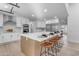 Large kitchen island with ample seating and stunning quartz countertops at 6613 W Sweetwater Ave, Glendale, AZ 85304