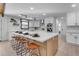 Modern kitchen with white cabinets, quartz countertops, and stainless steel appliances at 6613 W Sweetwater Ave, Glendale, AZ 85304
